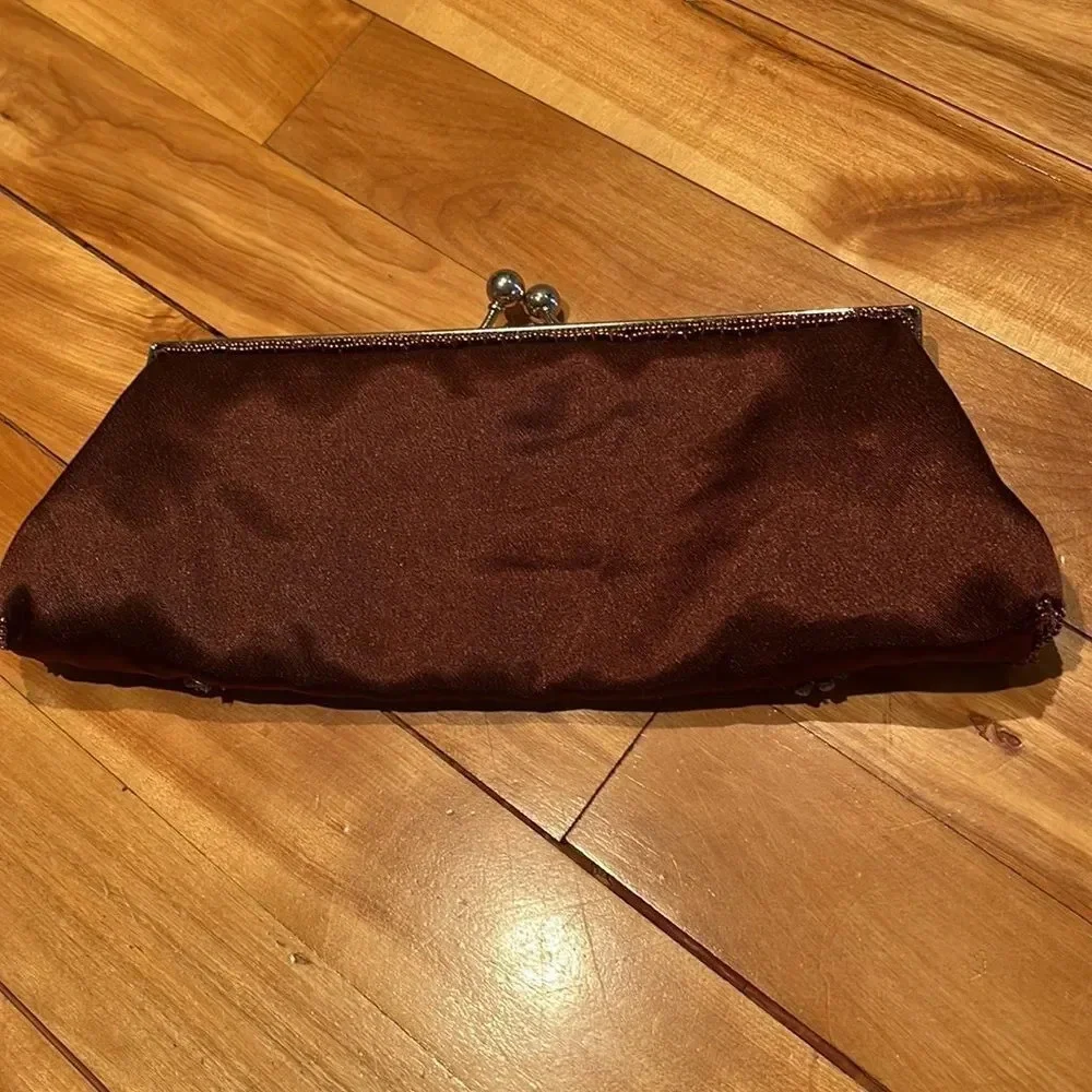 Satiny chocolate brown crystal and bead accent ball snap closure clutch.